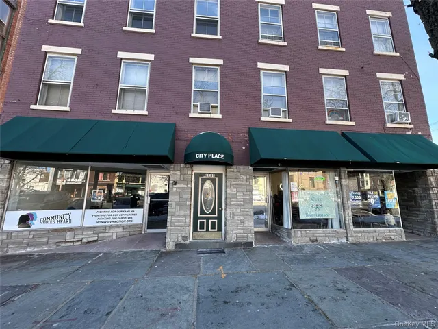 a view of a brick building with many windows