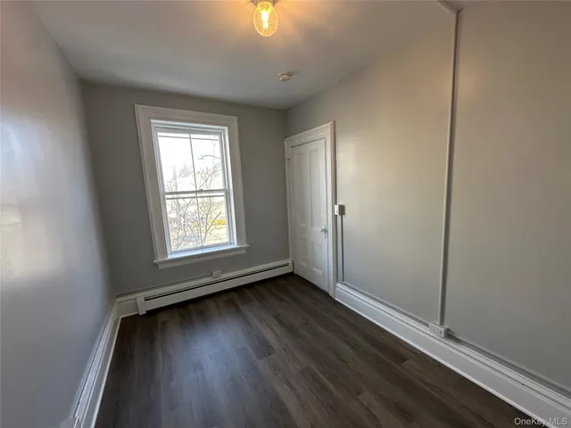 a view of room with window and hardwood floor