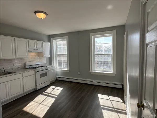 a kitchen with granite countertop stainless steel appliances lots of counter top space