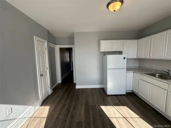a kitchen with a refrigerator and a stove