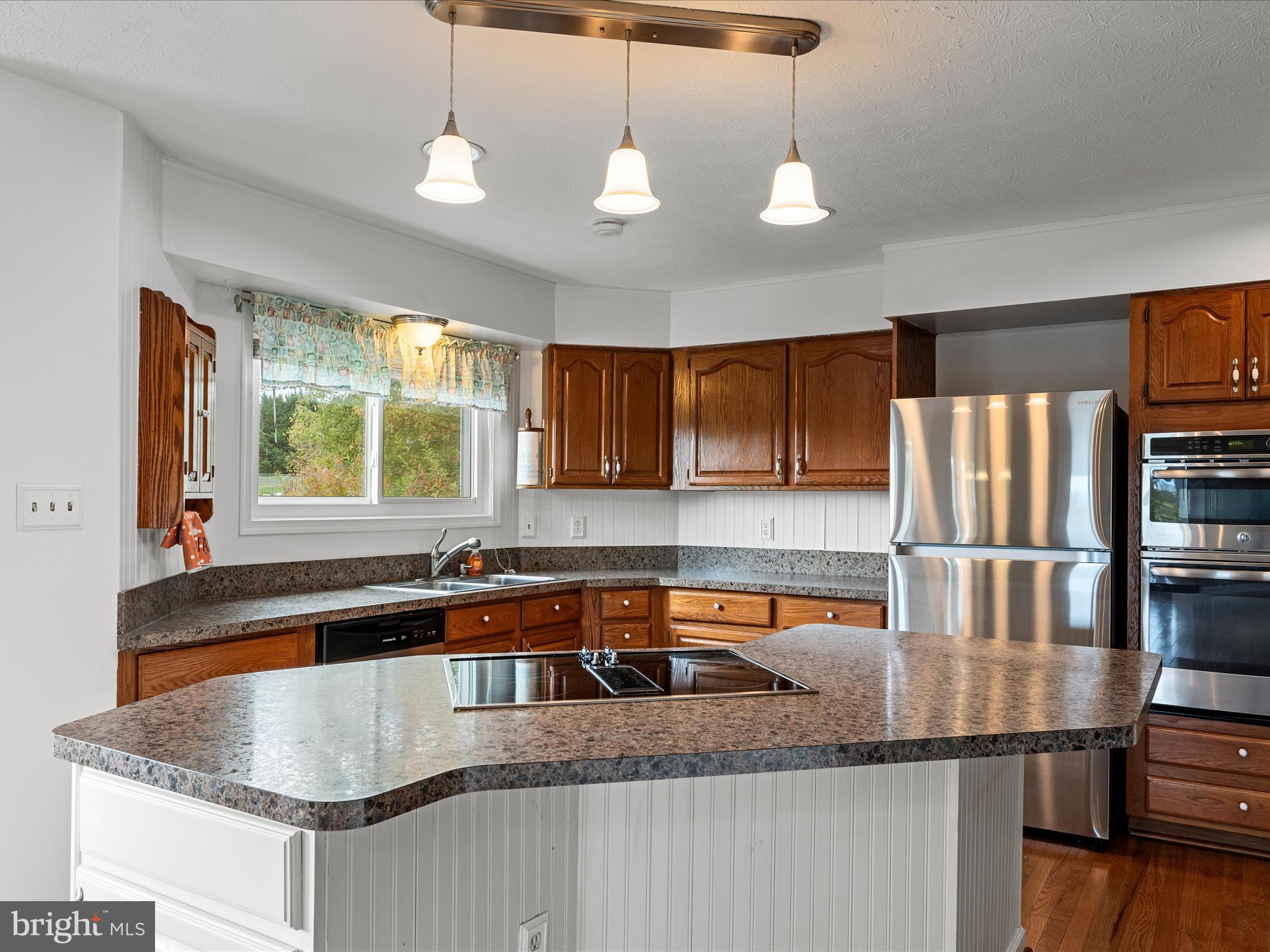 252 Punkin Ridge Drive Clear Brook, VA 22624 - Photo 39 of 80 a kitchen with stainless steel appliances granite countertop a sink a microwave and a refrigerator