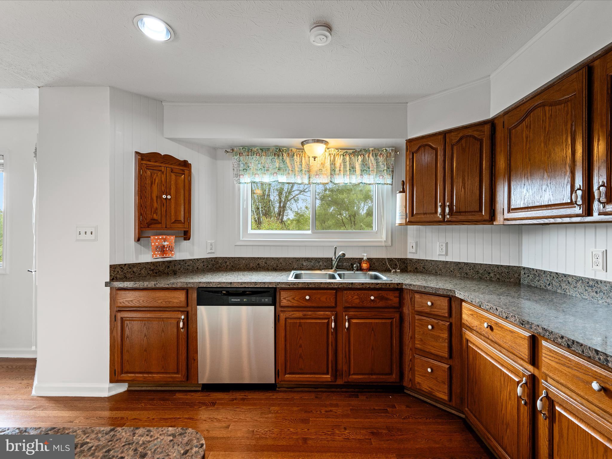 252 Punkin Ridge Drive Clear Brook, VA 22624 - Photo 40 of 80 a kitchen with stainless steel appliances granite countertop wooden cabinets sink and window