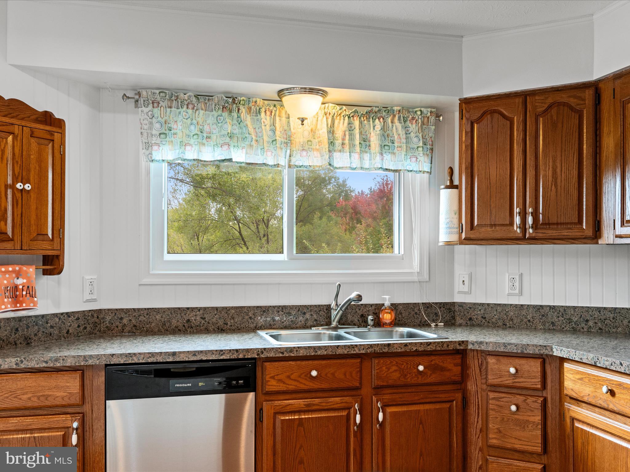 252 Punkin Ridge Drive Clear Brook, VA 22624 - Photo 41 of 80 a kitchen with granite countertop wooden cabinets a sink and a window