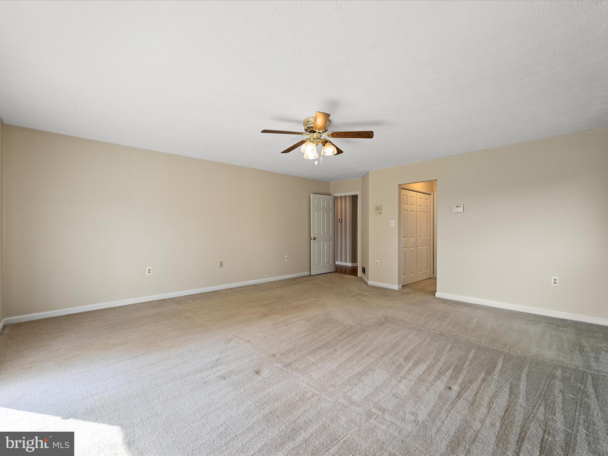 252 Punkin Ridge Drive Clear Brook, VA 22624 - Photo 50 of 80 an empty room with a ceiling fan and wooden floor
