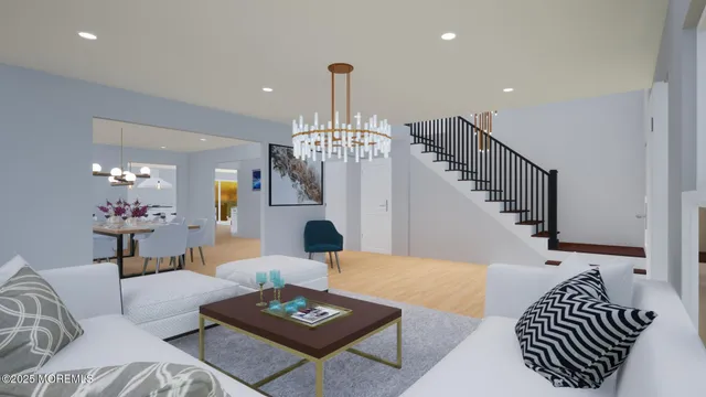 a living room with furniture kitchen view and a chandelier