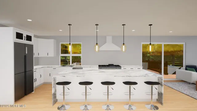 a kitchen with stainless steel appliances granite countertop a stove and a wooden floors