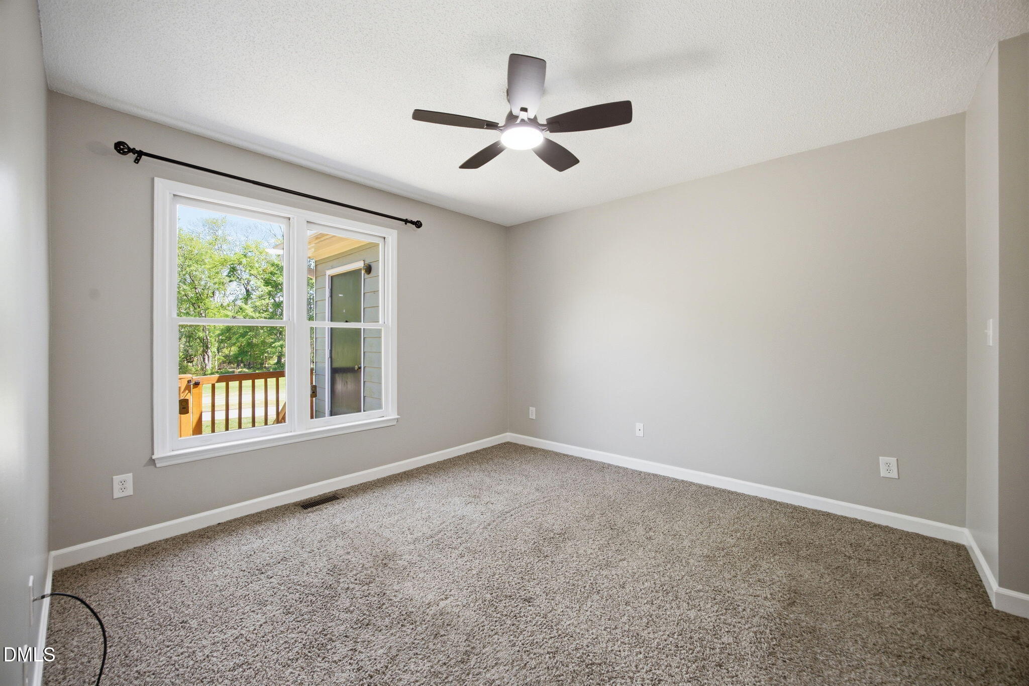 1626 Oakland Hills Way Raleigh, NC 27604 - Photo 14 of 25 an empty room with a window and a ceiling fan