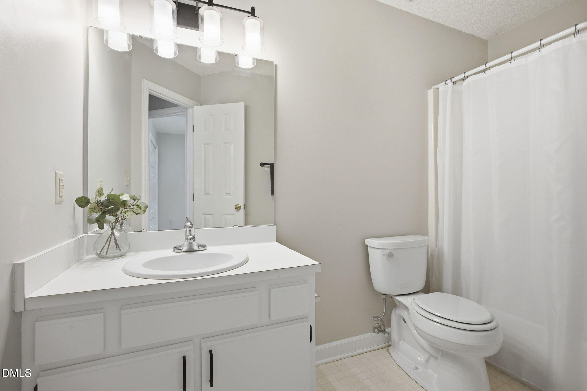 1626 Oakland Hills Way Raleigh, NC 27604 - Photo 16 of 25 a bathroom with a sink a toilet and a mirror