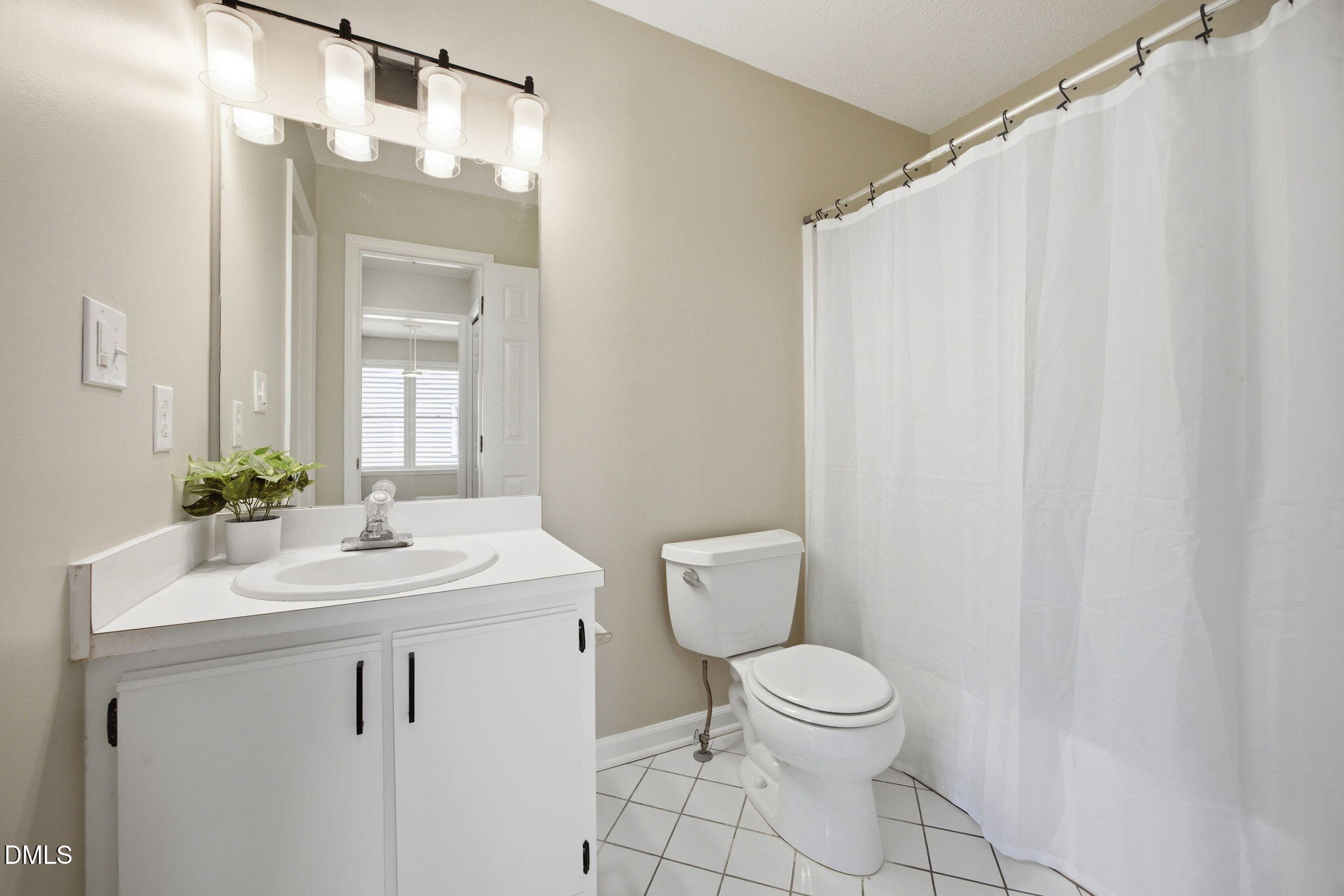1626 Oakland Hills Way Raleigh, NC 27604 - Photo 18 of 25 a bathroom with a toilet a sink and a mirror