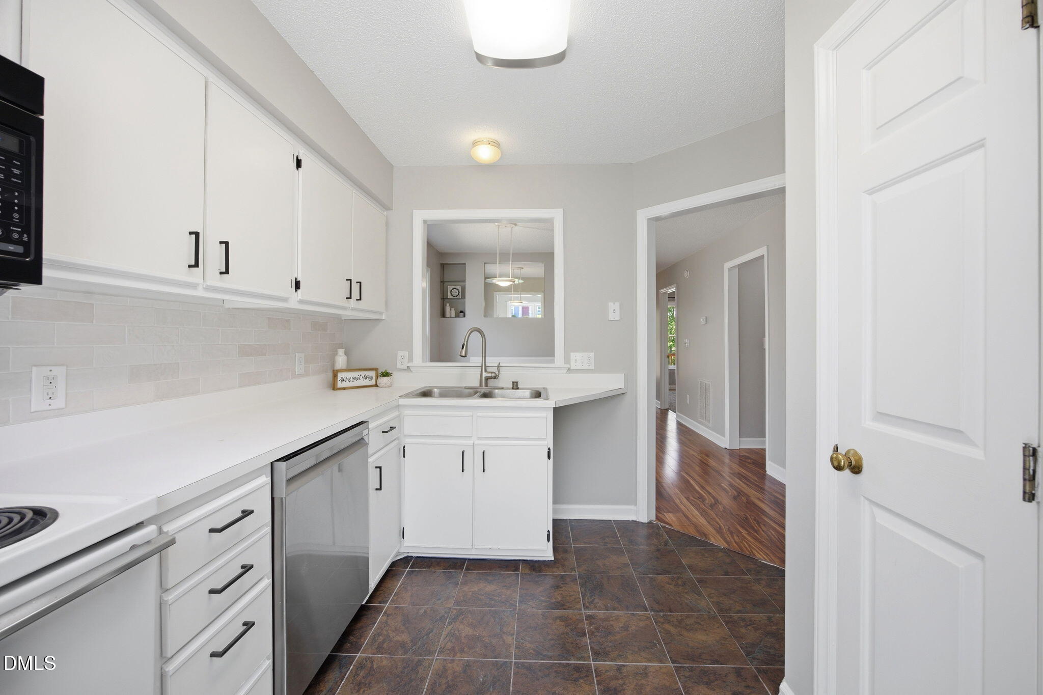 1626 Oakland Hills Way Raleigh, NC 27604 - Photo 9 of 25 a kitchen with a sink and cabinets