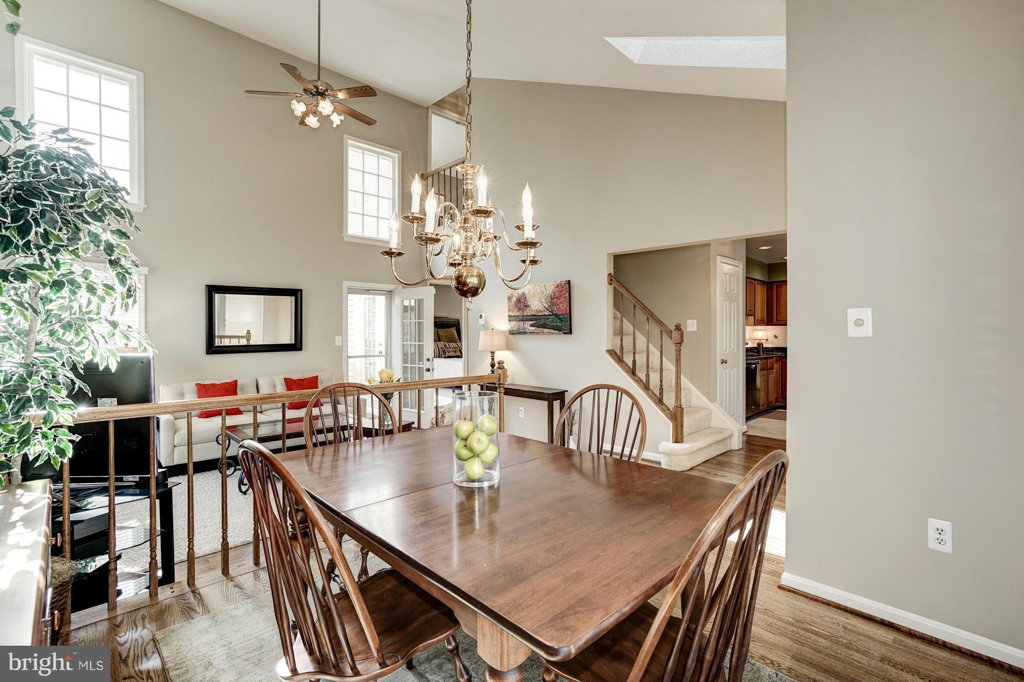 7415 Ridge Oak Court Springfield, VA 22153 - Photo 27 of 30 a dining room with furniture a chandelier and wooden floor