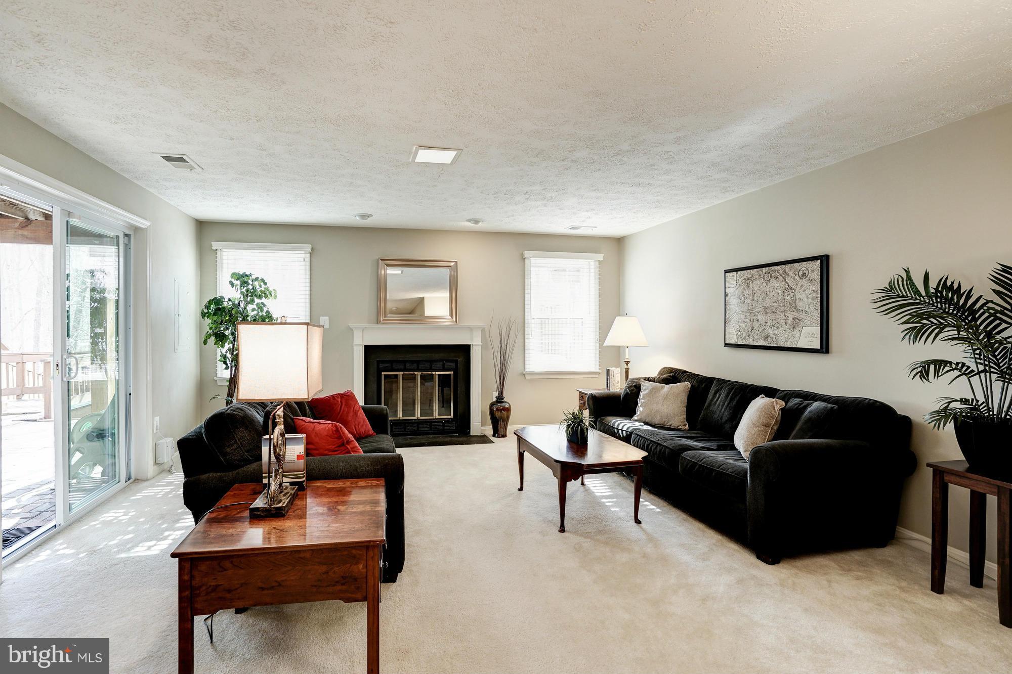 7415 Ridge Oak Court Springfield, VA 22153 - Photo 21 of 30 a living room with furniture a fireplace and a potted plant