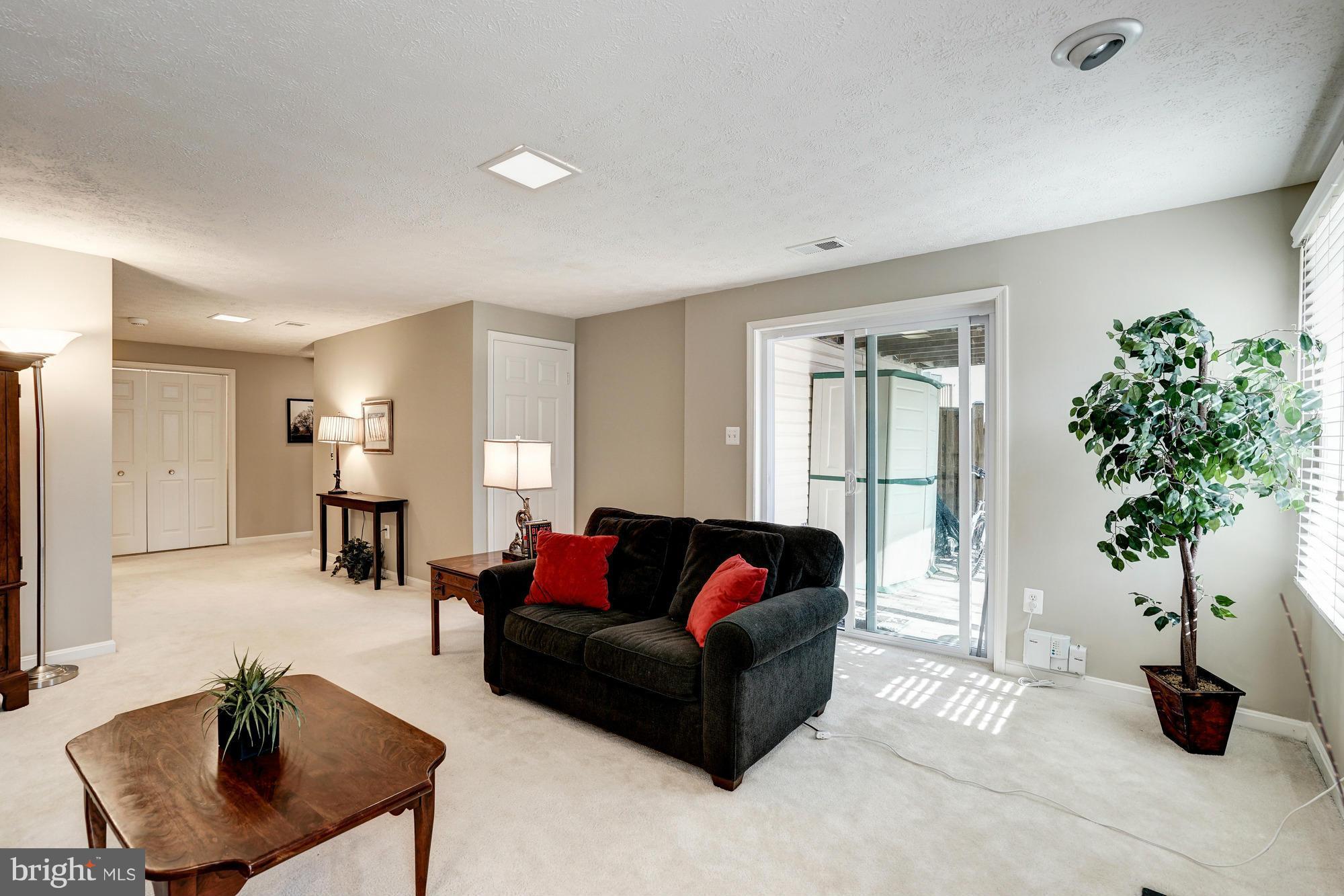 7415 Ridge Oak Court Springfield, VA 22153 - Photo 22 of 30 a living room with furniture potted plant and a window