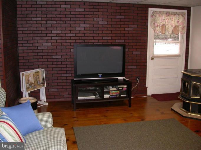 2520 Fairmount Road Hampstead, MD 21074 - Photo 5 of 12 a living room with furniture a flat screen tv and gym equipment
