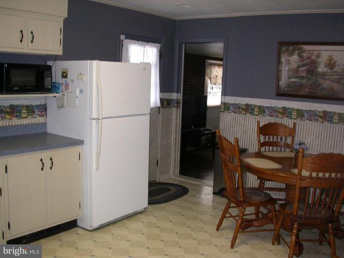 2520 Fairmount Road Hampstead, MD 21074 - Photo 7 of 12 a white refrigerator freezer sitting in a kitchen with stainless steel appliances granite countertop furniture and a refrigerator