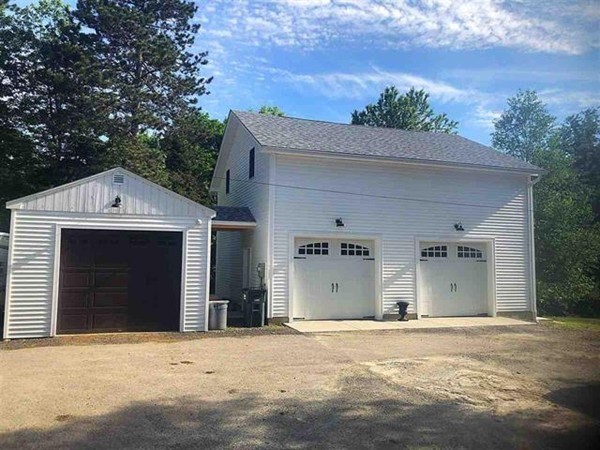 135 Thayer Road New Ipswich, NH 03071 - Photo 3 of 24 a front view of a house with a garage