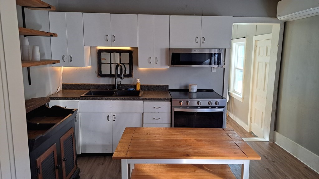 135 Thayer Road New Ipswich, NH 03071 - Photo 7 of 24 a kitchen with stainless steel appliances a stove refrigerator and cabinets