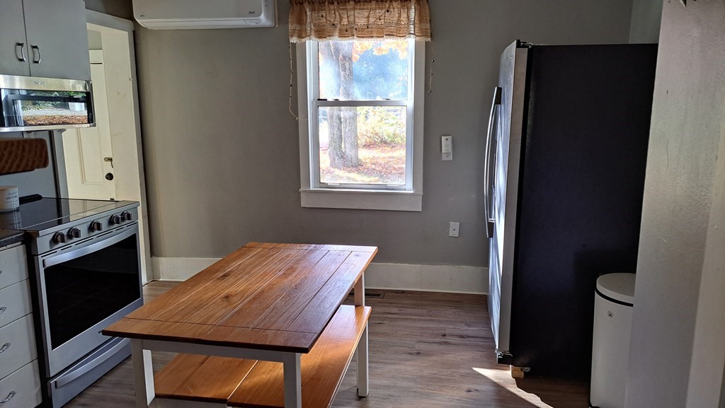 135 Thayer Road New Ipswich, NH 03071 - Photo 8 of 24 a view of a dining room with furniture window and wooden floor