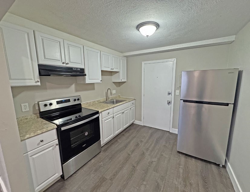 108 Franklin Street Lynn, MA 01902 - Photo 12 of 15 a kitchen with granite countertop a refrigerator stove and sink