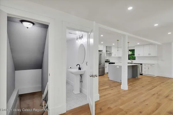 a open kitchen with white cabinets and stainless steel appliances