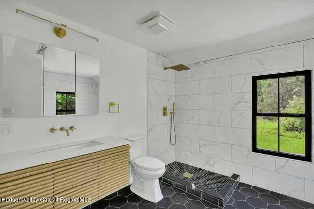 a bathroom with a sink toilet and shower