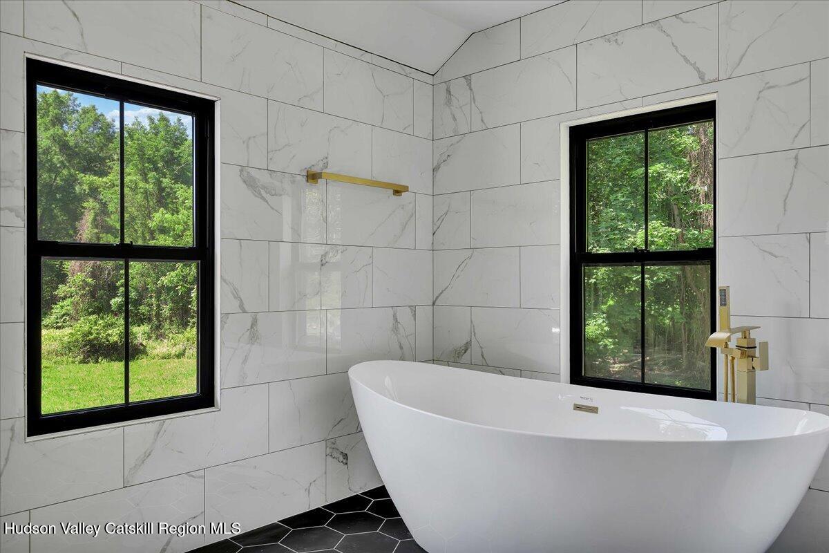 3603 County Rte 26 Greenville, NY 12083 - Photo 22 of 36 a white bath tub sitting in a bathroom next to a window