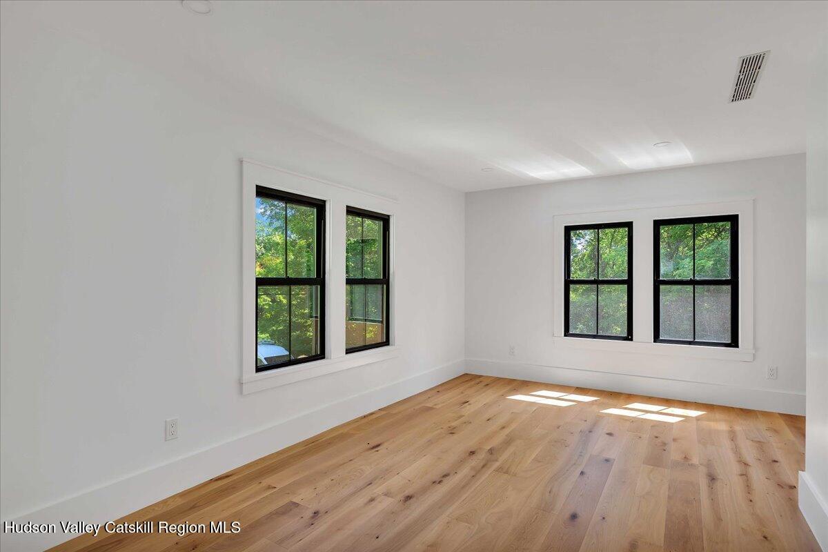 3603 County Rte 26 Greenville, NY 12083 - Photo 25 of 36 a view of an empty room with wooden floor and a window