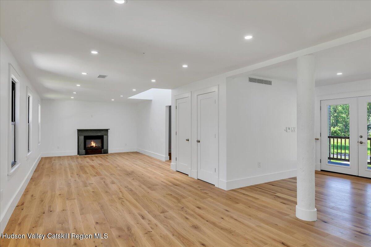 3603 County Rte 26 Greenville, NY 12083 - Photo 3 of 36 a view of an empty room with wooden floor and a window