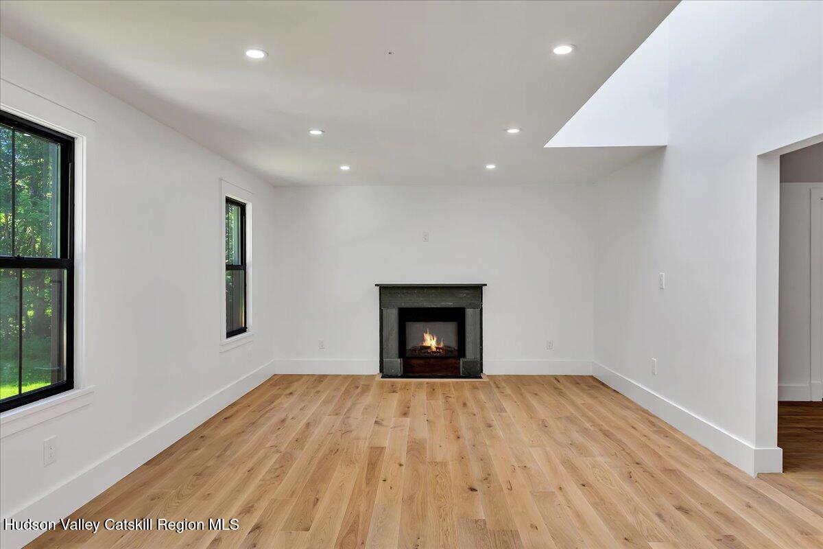 3603 County Rte 26 Greenville, NY 12083 - Photo 4 of 36 a view of empty room with wooden floor and fireplace