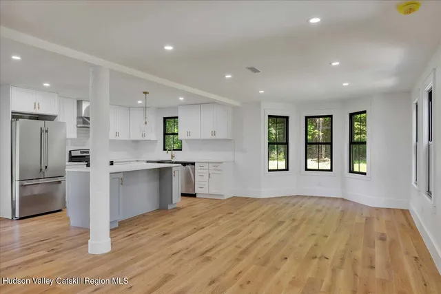 a kitchen with a refrigerator and a window