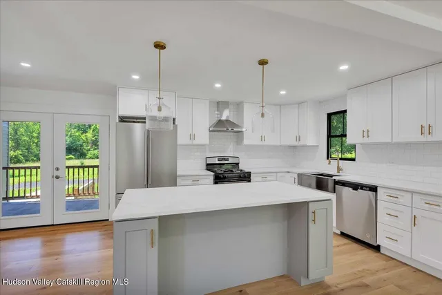 a kitchen with a refrigerator a sink and wooden cabinets