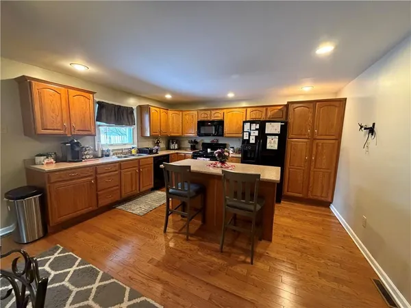 a kitchen with a table chairs refrigerator and microwave