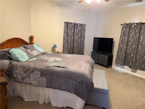 a bedroom with a bed and a flat screen tv
