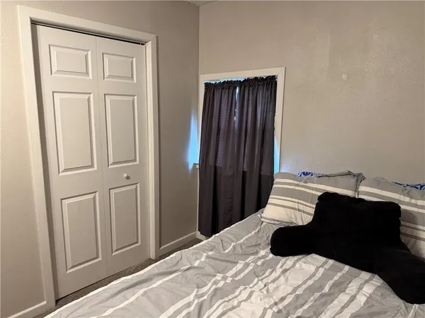 a bedroom with a bed and a closet