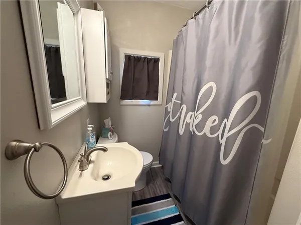 a bathroom with a sink a mirror and a window