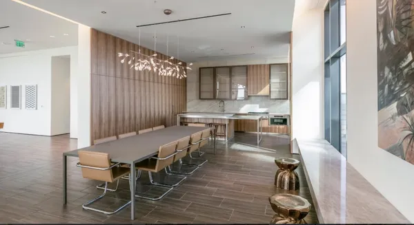 a kitchen with kitchen island a stove a table and chairs in it