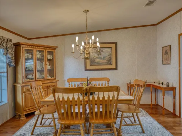 a view of a dining room with furniture wooden floor and chandelier