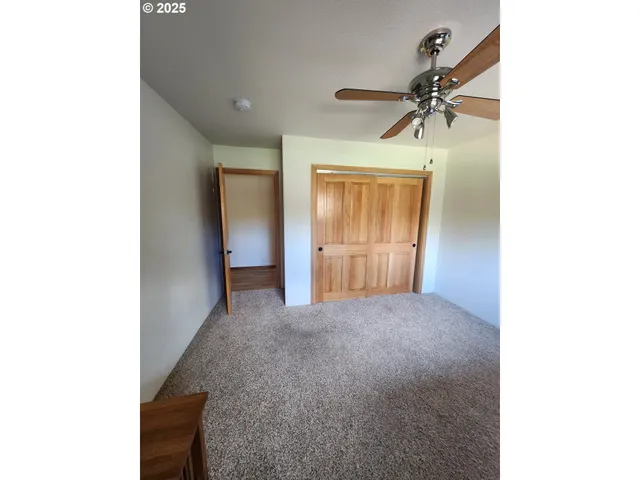 a kitchen with a sink cabinets and wooden floor