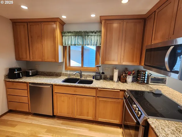 a kitchen with a sink cabinets and a window