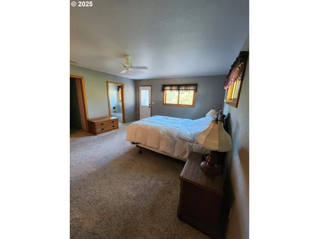 a front view of a house with a yard and fountain