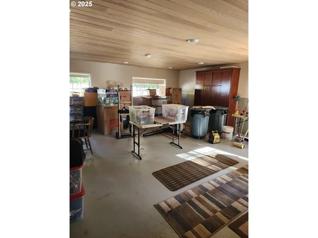 a view of a dining room with furniture and a chandelier