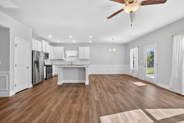 a view of kitchen with wooden floor and electronic appliances