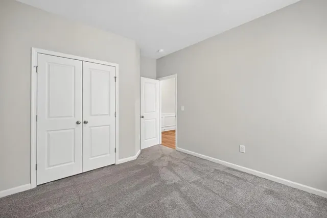 a view of an empty room and closet area