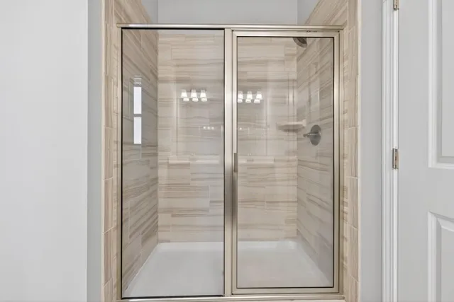 a bathroom with a glass shower door