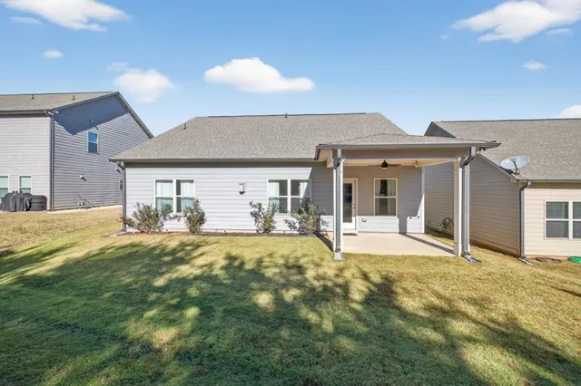 a view of a house with a yard and garage