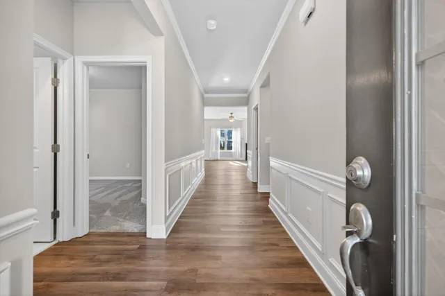 a view of a hallway with wooden floor
