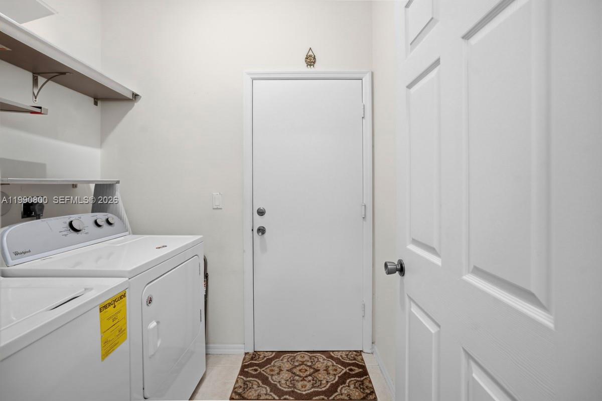 337 Southwest Maclay Way Port St. Lucie, FL 34986 - Photo 32 of 44 a utility room with dryer and washer