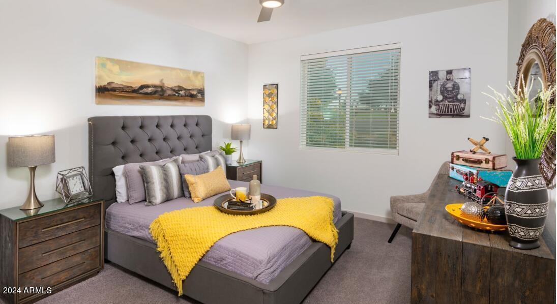 3700 East Williams Field Road, Unit 1 Gilbert, AZ 85295 - Photo 3 of 17 a bedroom with a bed and wooden floor