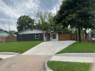 a front view of a house with a yard and a garage