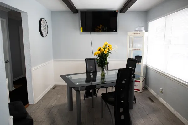 a view of a dining room with furniture and wooden floor